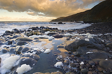 Rocky North Sea foreshore at dusk, Scottish borders, Scotland