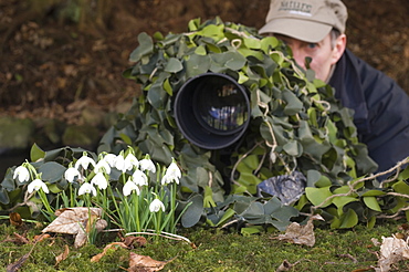 Wildlife photographer with camouflaged camera, Angus, Scotland