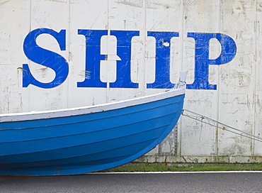 Faroese boat in front of a disused shipping container, Vagar, Faroe Islands