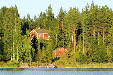 Finnish summer house on a wooded island in Lake Saimaa by sunset light, near Savonlinna, Finland, Scandinavia, Europe