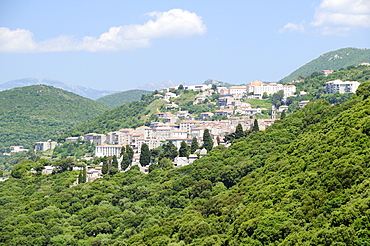 View of Sartene town in wooded mountainous setting, Corsica, France, Europe