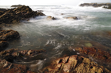 Sea swirling around rocks, near Polzeath, Cornwall, England, United Kingdom, Europe