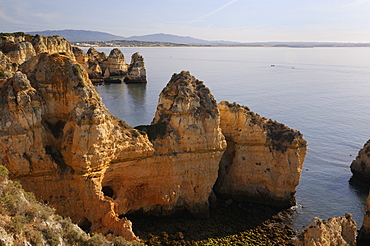 Weathered sandstone cliffs and sea stacks at Ponta da Piedade, Lagos, Algarve, Portugal, Europe