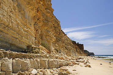 Weathered, layered sandstone cliffs at Praia do Mos, Lagos, Algarve, Portugal, Europe