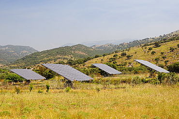 Solar farm with four Photovoltaic solar trackers, near Antissa, Lesbos (Lesvos), Greece. MORE INFO: Solar trackers automatically rotate and tilt photovoltaic panels to follow the sun throught the day, maximising sunlight absorpton rates. Several of these Solar farms have been built on Lesbos since 2010.