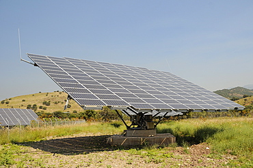 Photovoltaic solar tracker at a solar farm near Antissa, Lesbos (Lesvos), Greece. MORE INFO: Solar trackers automatically rotate and tilt photovoltaic panels to follow the sun throught the day, maximising sunlight absorpton rates. Several of these Solar farms have been built on Lesbos since 2010.