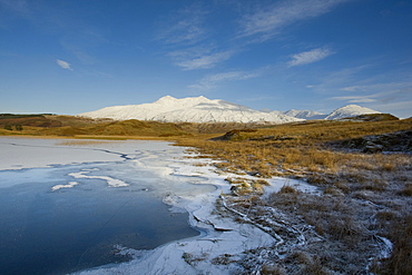 A frozen Loch Tromlee with snow capped Ben Cruachan in background. Loch Tromlee and Ben Cruachan, Argyll, Scotland