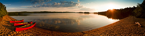 Canoes on the lake shore at sunset, Algonquin National Park, Ontario, Canada, North America