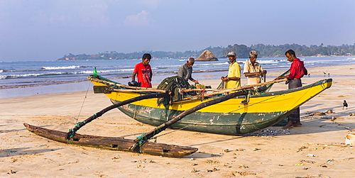 Fishermen sorting their catch on Weligama Beach, South Coast of Sri Lanka, Asia 