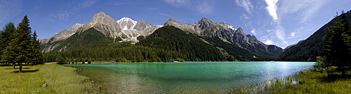 The Antholzer lake in idyllic mountain scenery in the sunlight, Val Pusteria, South Tyrol, Italy, Europe