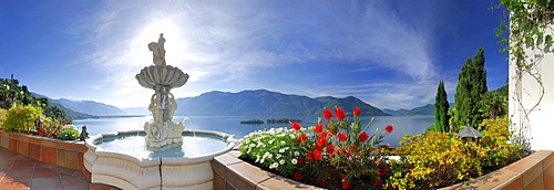 Panorama of lake Maggiore with isle of Brissago, Isole di Brissago, and Monte Gambarogno, fountain and flowers in the foreground, Ronco sopra Ascona, lake Maggiore, Lago Maggiore, Ticino, Switzerland