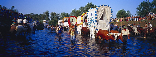 Pilgrims crossing the river Rio Quema, Andalusia, Spain