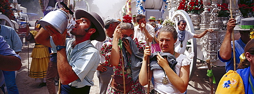 Pilgrims suffering from the heat and dust on the sandy Raya Real, Andalusia, Spain