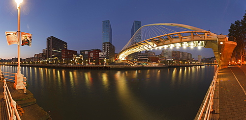 Illuminated pedestrian bridge Zubizuri above Rio Nervion in the evening, Bilbao, Province of Biskaia, Basque Country, Euskadi, Northern Spain, Spain, Europe