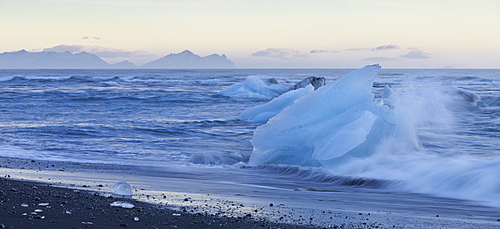 Icebergs in the waves in the glacial lake, Jokulsarlon, East Iceland, Iceland