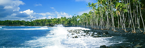 Hawaii, Big Island, Ocean surf crashing on Kalapana Black Sand Beach.