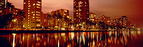 Hawaii, Oahu, Waikiki at dusk, Glow of city lights on Ala Wai Canal.