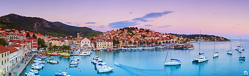 Elevated view over the picturesque harbour town of Hvar illuminated at dusk, Hvar, Dalmatia, Croatia, Europe