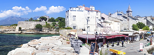 Promenade at the port of Saint Florent with the church of Santa Maria Assunta and the Citadel, Saint Florent, Corsica, France, Mediterranean, Europe 