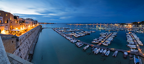 Dusk lights the harbor and the medieval old town of Otranto, Province of Lecce, Apulia, Italy, Europe