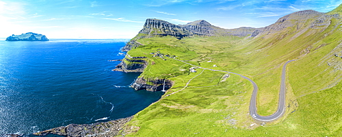 Panoramic of the road in between meadows and ocean, Gasadalur, Vagar Island, Faroe Islands, Denmark, Europe