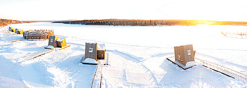 Wood cabins rooms of the luxury Arctic Bath Spa Hotel floating on frozen river Lule covered with snow, Harads, Lapland, Sweden, Scandinavia, Europe