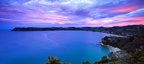 Dusk falls above Cooks Bay on the Pacific Ocean coast of the Coromandel Peninsula, North Island, New Zealand, Pacific