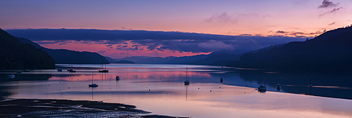 Panorama of Queen Charlotte Sound at dawn with the pink sky and anchored boats reflected in the still water around Okiwa Bay, Marlborough, South Island, New Zealand, Pacific