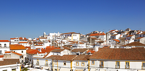 Panoramic cityscape view over pan tile rooftops and whitewashed buildings in the city centre of Evora, Alto Alentejo, Portugal, Europe