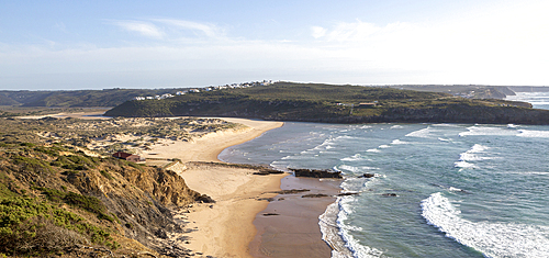 Panorama view of river mouth of Ribeira de Aljezur reaching the Atlantic Ocean and whitewashed buildings of Clero village, Aljezur, Algarve, Portugal, Europe