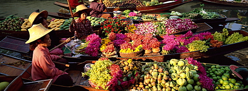 Women market traders in boats laden with fruit and flowers, Damnoen Saduak floating market, Bangkok, Thailand, Southeast Asia, Asia