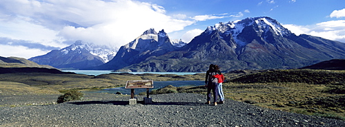 Tourists looking towards the Cuernos del Paine mountains, Torres del Paine National Park, Patagonia, Chile, South America