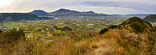 Aso volcanic calder, see from Shiroyama viewpoint, with profile of Nakadake volcano like Sleeping Buddha; Kyushu, Japan