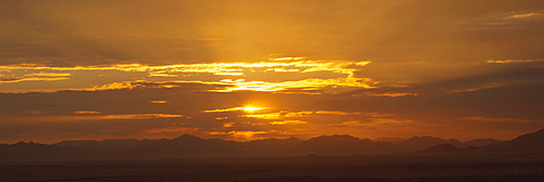 Panoramic view of sunset over mountains in the Namib Rand private reserve, Namib Desert, Namibia, Africa