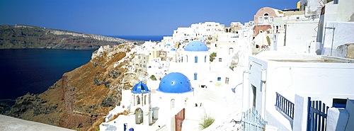 View of Oia with blue domed churches and whitewashed buildings, Santorini (Thira), Cyclades Islands, Greek Islands, Greece, Europe