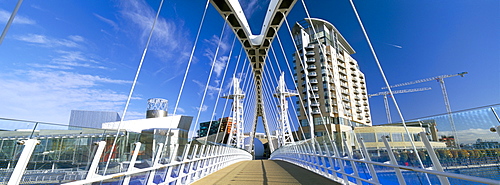 View along pedestrian suspension bridge at Salford Quays, Salford, Manchester, England, United Kingdom, Europe