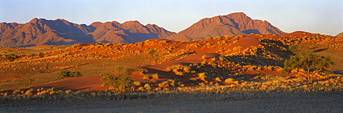 Panoramic view of mountains and dune glowing in last light before sunset, Namib Rand, Namib Naukluft Park, Namibia, Africa