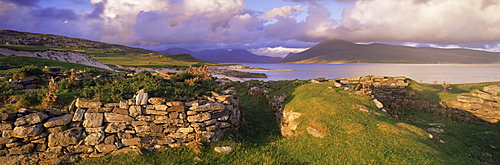 View towards Isle of Lewis from ruins of Blackhouses, Paible, Taransay, Outer Hebrides, Scotland, United Kingdom, Europe