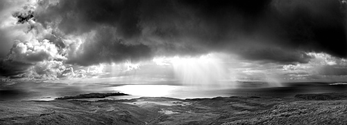 Panoramic view from An Sgurr on the Isle of Eigg, looking towards a storm over the sea between Eigg and the mainland, Highland, Scotland, United Kingdom, Europe