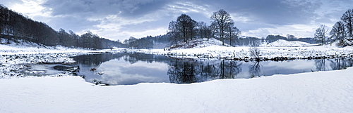 Winter view of River Brathay at dawn, under snow with reflections, near Elterwater Village, Ambleside, Lake District National Park, Cumbria, England, United Kingdom, Europe