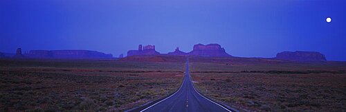 Highway passing through an arid landscape, Monument Valley, Arizona, USA