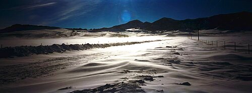 Road passing through a snow covered landscape, Cascade, Montana, USA