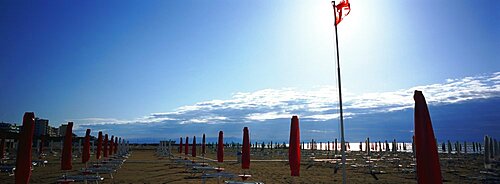 Beach umbrella and beach chairs on the beach, Lignano Sabbiadoro, Italy