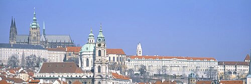 Low angle view of a church and a castle, Hradcany Castle, St. Nicholas Church, Prague, Czech Republic