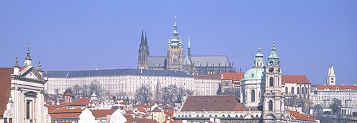 Low angle view of a church and a castle, Hradcany Castle, St. Nicholas Church, Prague, Czech Republic