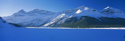 Low angle view of snowcapped mountains, Num-Ti-Jah Lodge, Bow Lake, Icefield Parkway, Banff National Park, Alberta, Canada