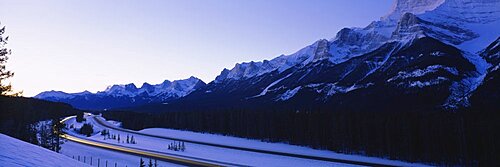 Low angle view of snowcapped mountains, Mt Rundle, Three Sisters, Canmore, Alberta, Canada