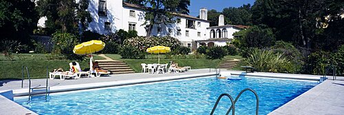 Three people at the poolside, Qunita de Sao Thiago Hotel, Sintra, Portugal