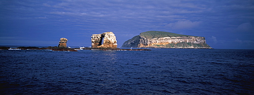 Spectacular sea arch off the volcanic cliffs of Darwin Island one of the newest and most northerly of the Galapagos Islands, Ecuador