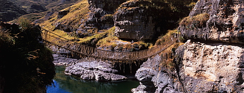 Famous Incan grass-rope suspension bridge across Apurimac River rebuilt annually since Incan period and only one still in existence, Inca Road, Altiplano, Peru